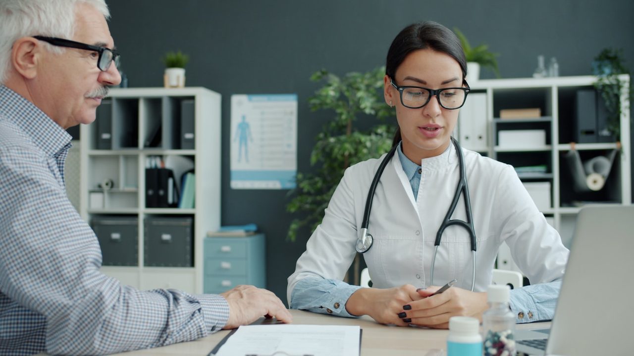 A GP discussing a procedure with a patient